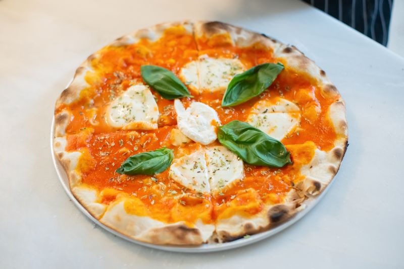 Signature marco's pizza with fresh toppings at Marcos Buffalo